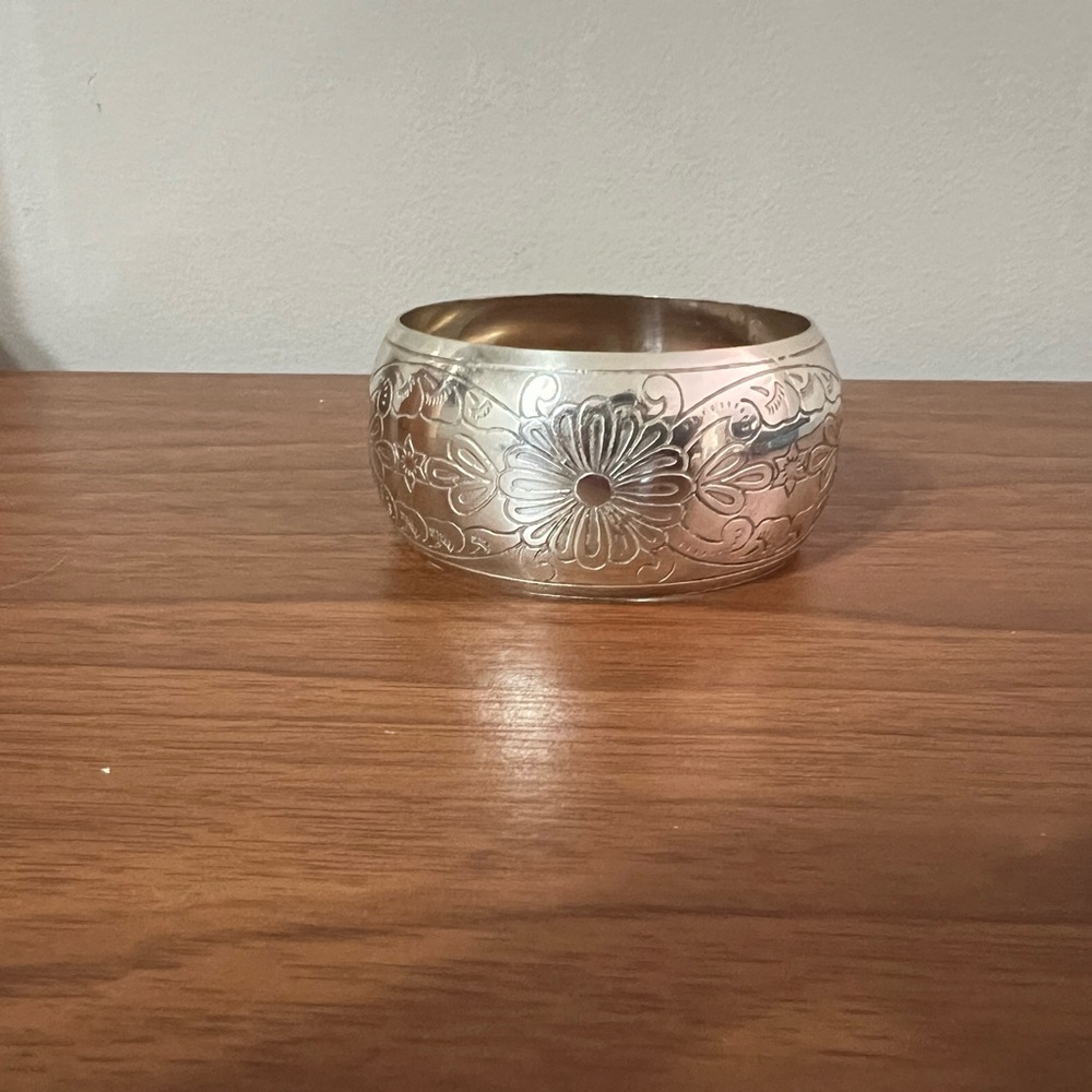 Silvertone, bangle bracelet, with detail flower etchings engraved.